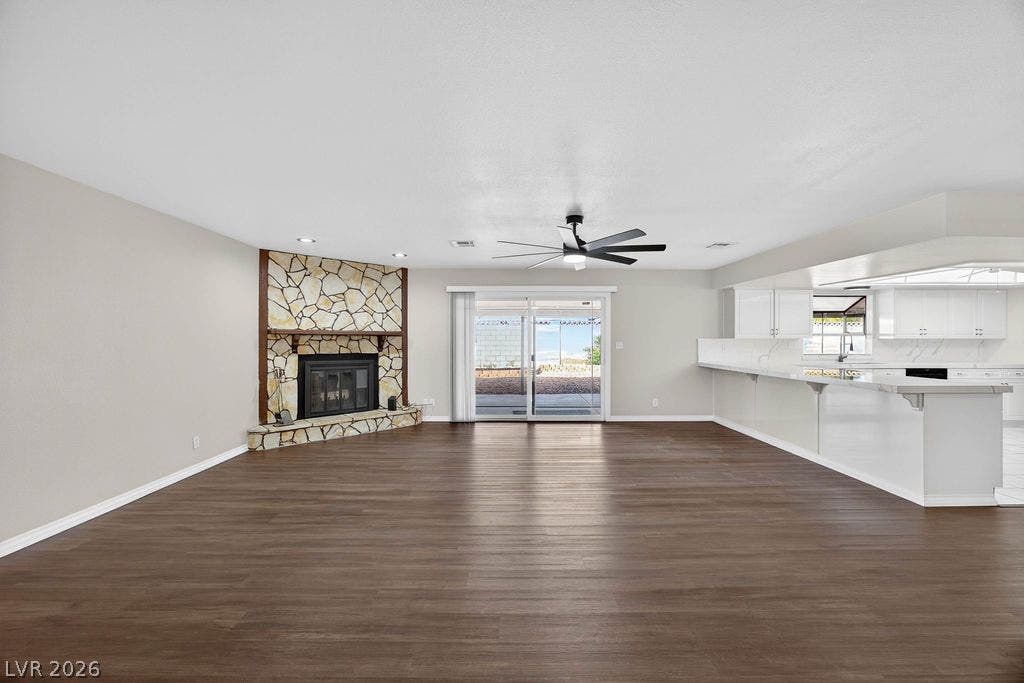 3189 Casanova Circle, Las Vegas, NV 89120 An open floorplan seamlessly connects the spacious living area with a stone fireplace to the kitchen.