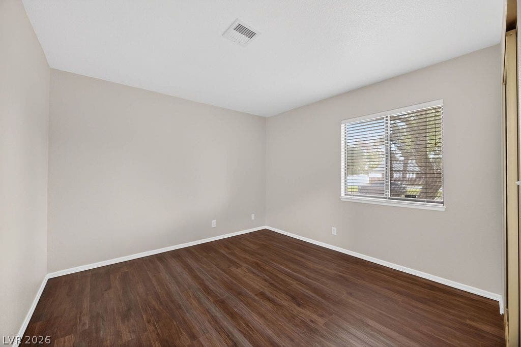 3189 Casanova Circle, Las Vegas, NV 89120 BED #2 Rich wood-look flooring and a wide window with blinds define this versatile bedroom.