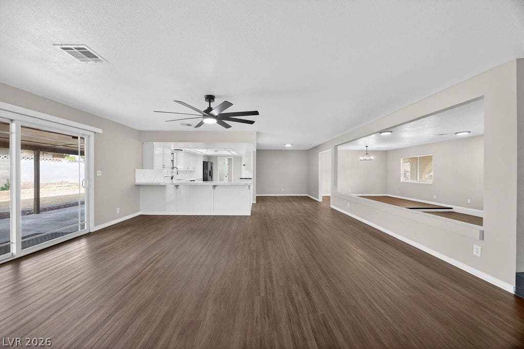 3189 Casanova Circle, Las Vegas, NV 89120 Rich wood-inspired floors anchor this airy living area connecting seamlessly to the kitchen.