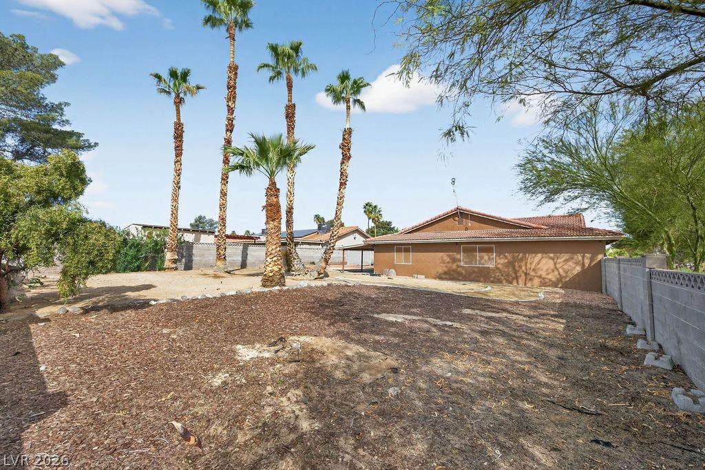 3189 Casanova Circle, Las Vegas, NV 89120 Towering palm trees frame the spacious rear side yard bordered by a block wall.