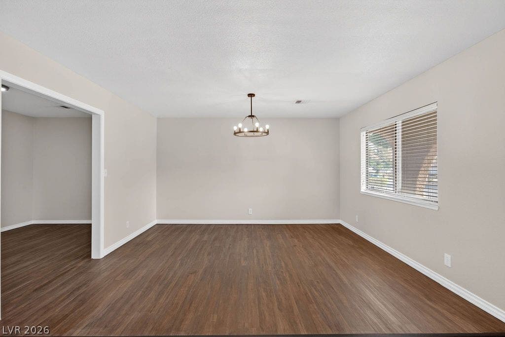 3189 Casanova Circle, Las Vegas, NV 89120 Rich wood-look flooring and a classic light fixture define this versatile dining area.