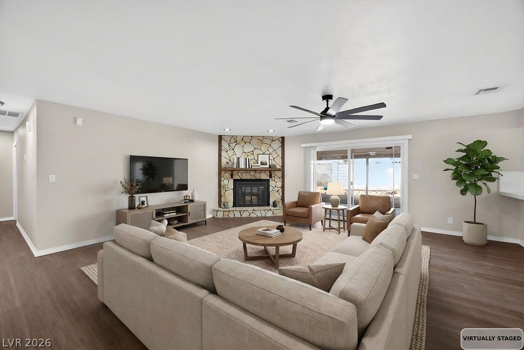 3189 Casanova Circle, Las Vegas, NV 89120 STAGED Smooth wood floors and a stone fireplace anchor this welcoming open living space.
