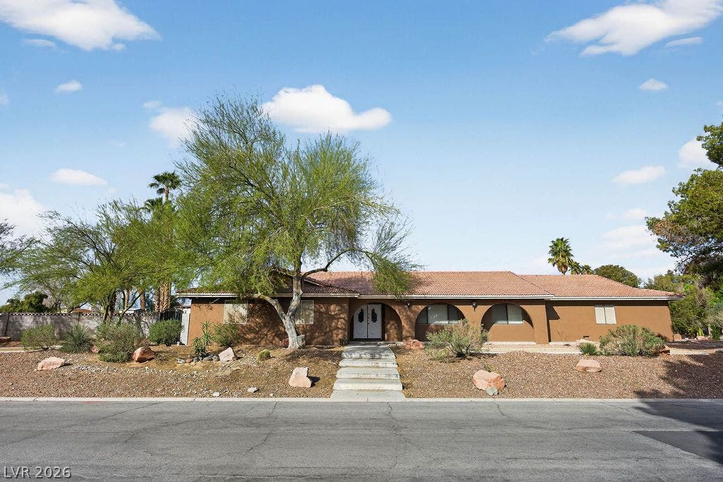3189 Casanova Circle, Las Vegas, NV 89120 A classic tile roof and arched architectural details define this sprawling single-story exterior.