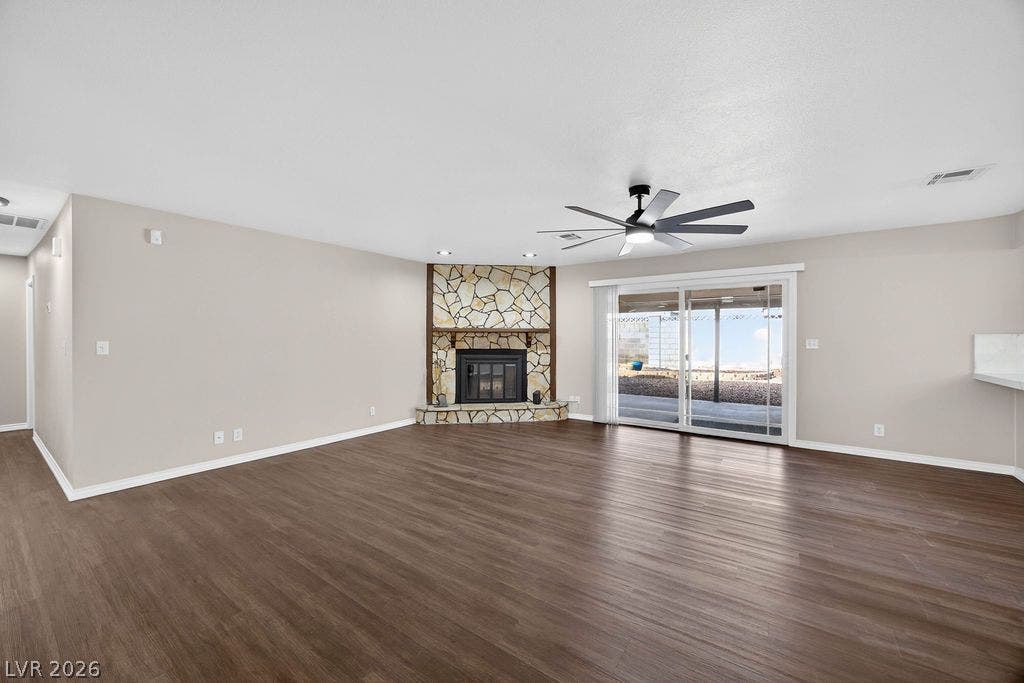 3189 Casanova Circle, Las Vegas, NV 89120 Warm wood-look flooring and a stone-clad fireplace anchor this inviting, open living space.