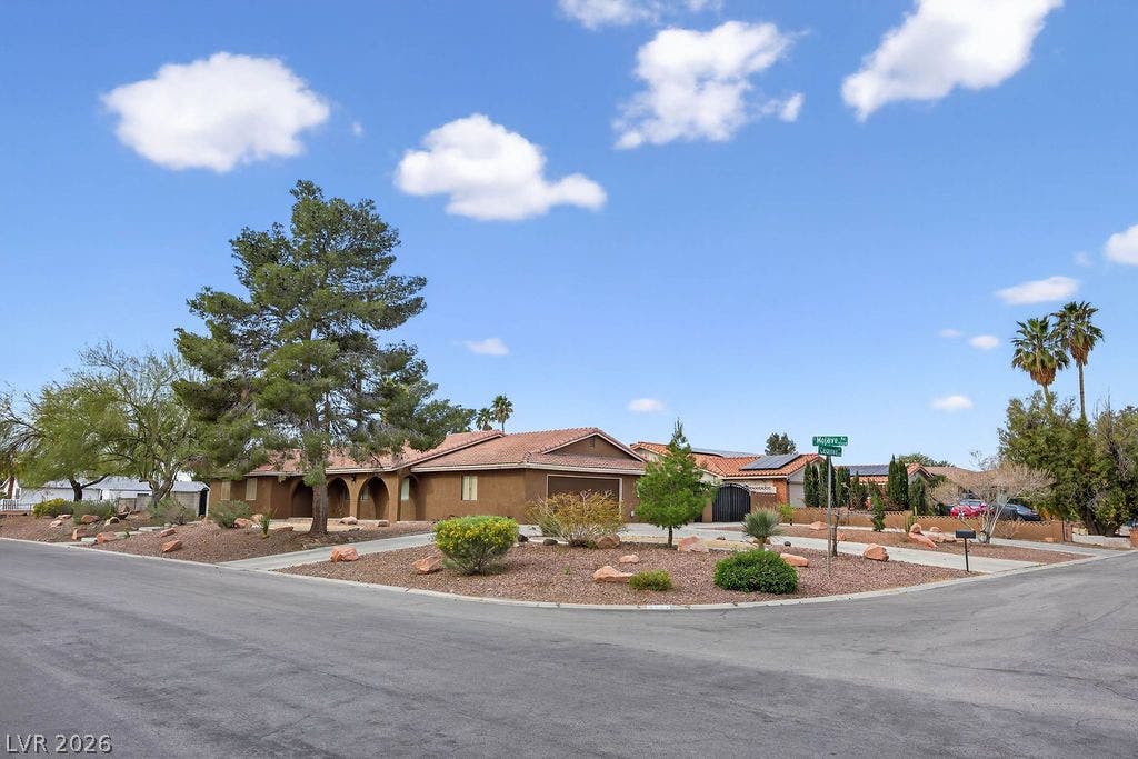 3189 Casanova Circle, Las Vegas, NV 89120 A classic Spanish tile roof crowning a textured stucco exterior on a corner lot.