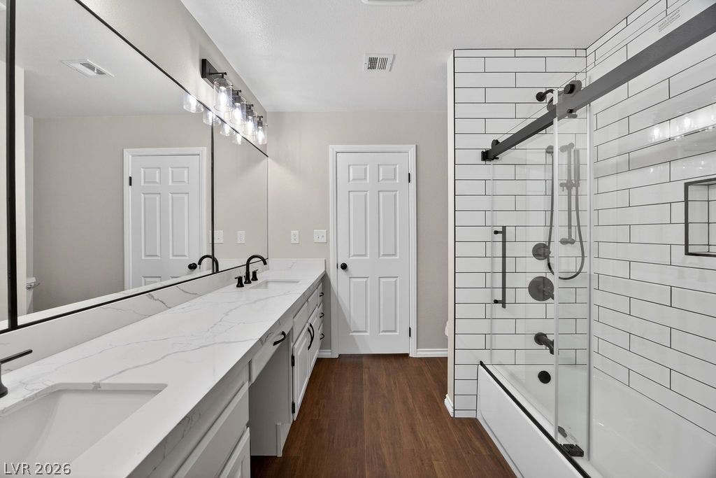 3189 Casanova Circle, Las Vegas, NV 89120 2nd Bath A long quartz double vanity complements a contemporary tiled tub shower assembly.