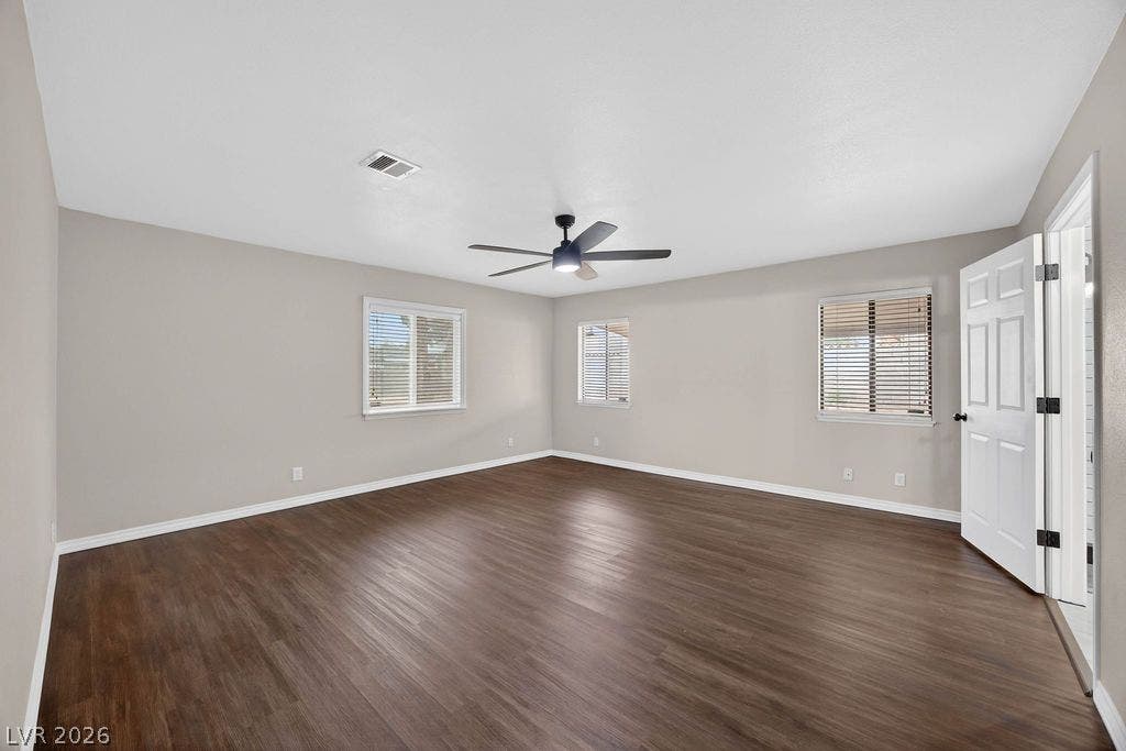 3189 Casanova Circle, Las Vegas, NV 89120 Rich wood-look flooring and multiple windows create a welcoming foundation in this versatile room.