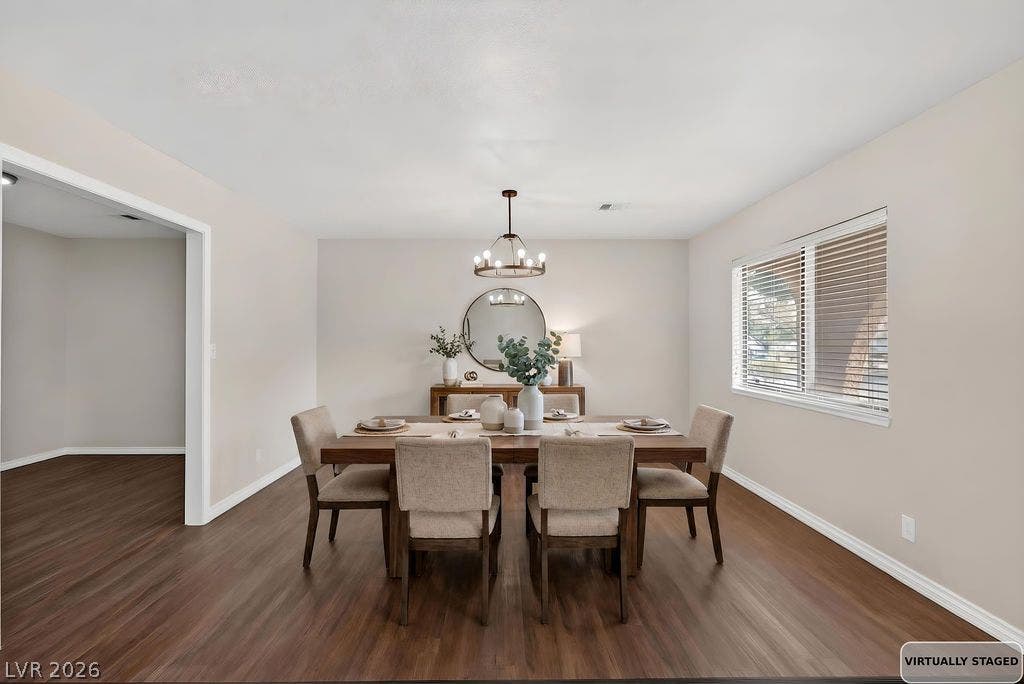 3189 Casanova Circle, Las Vegas, NV 89120 STAGED Rich wood-look flooring and a classic chandelier anchor this inviting dining space.