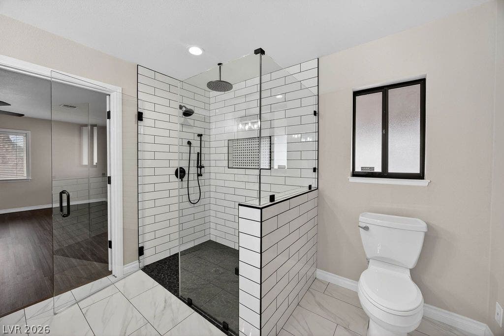 3189 Casanova Circle, Las Vegas, NV 89120 Modern tile work and glass panels highlight a meticulously designed walk-in shower.