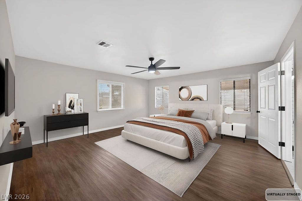 3189 Casanova Circle, Las Vegas, NV 89120 STAGED -Rich wood flooring runs throughout this spacious bedroom illuminated by multiple windows.