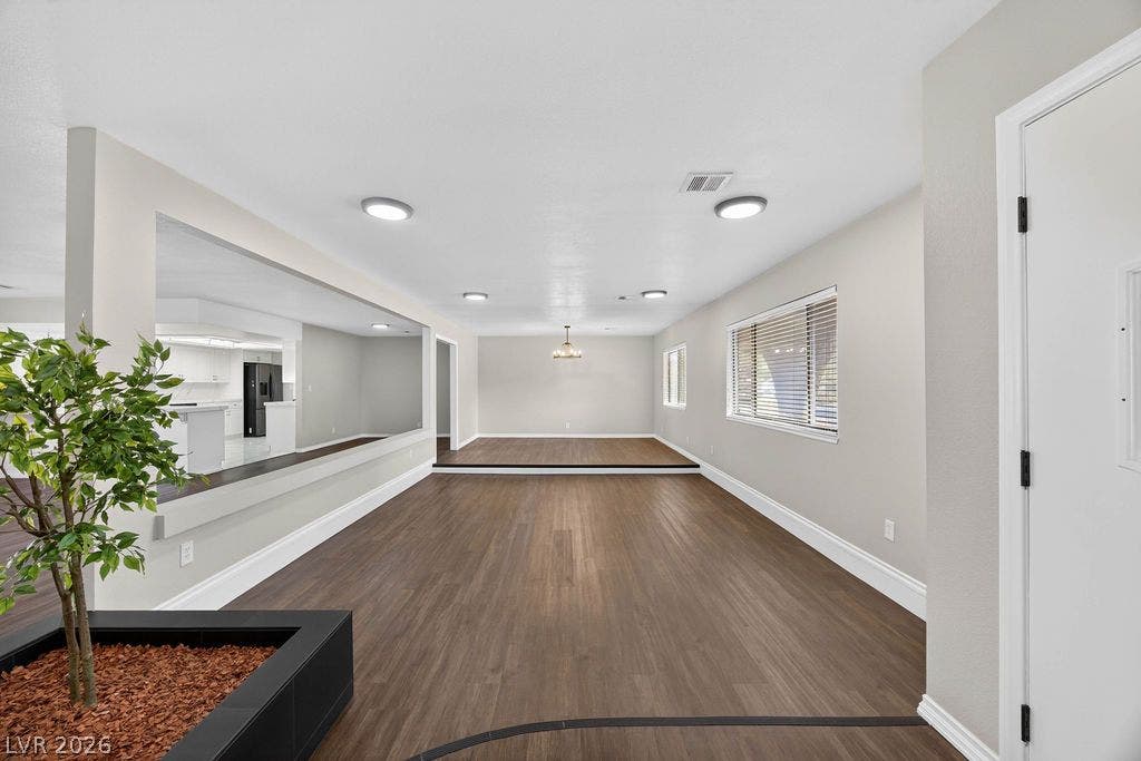 3189 Casanova Circle, Las Vegas, NV 89120 Rich wood-look flooring and clean white trim define this versatile, multi-level living area.