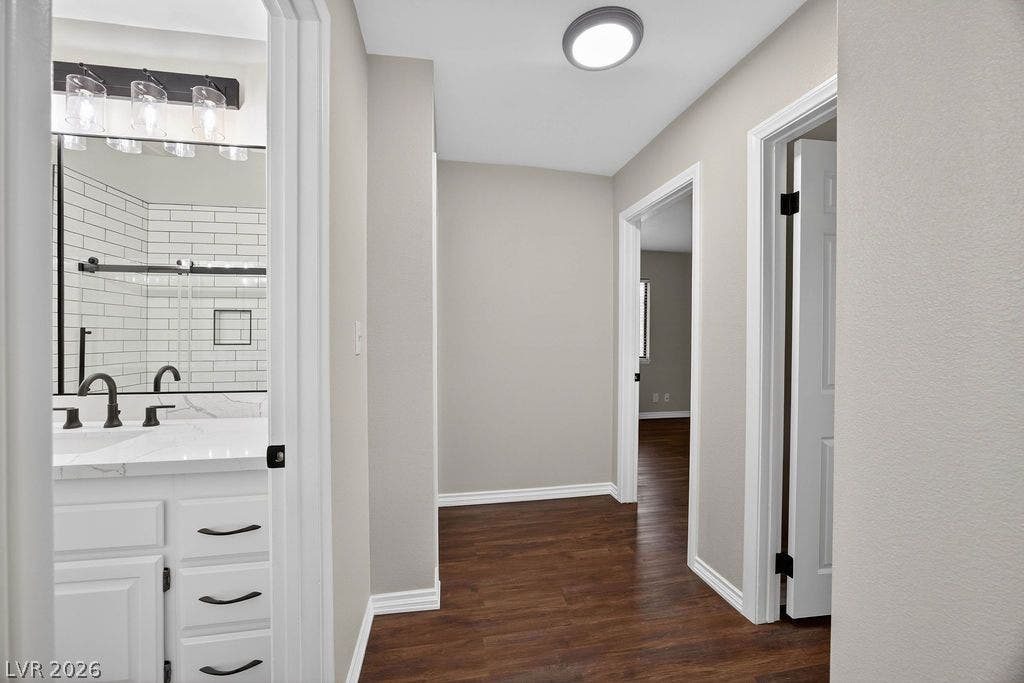3189 Casanova Circle, Las Vegas, NV 89120 Rich wood-look flooring connects this central hallway to bedrooms and a modern bathroom.