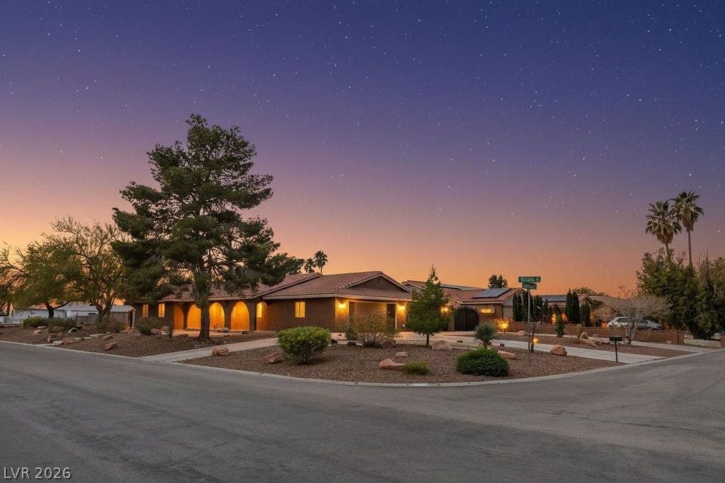 3189 Casanova Circle, Las Vegas, NV 89120 Stately desert landscaping frames the classic arched entryways of this warm Southwestern facade.