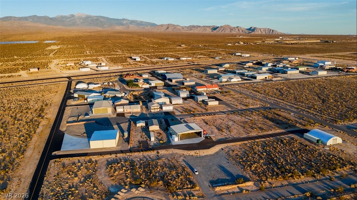 Dramatic mountain ranges frame this extensive desert neighborhood and its collection of outbuildings.