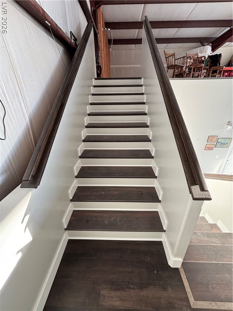 Rich wood treads and crisp white risers define this elegant modern staircase.