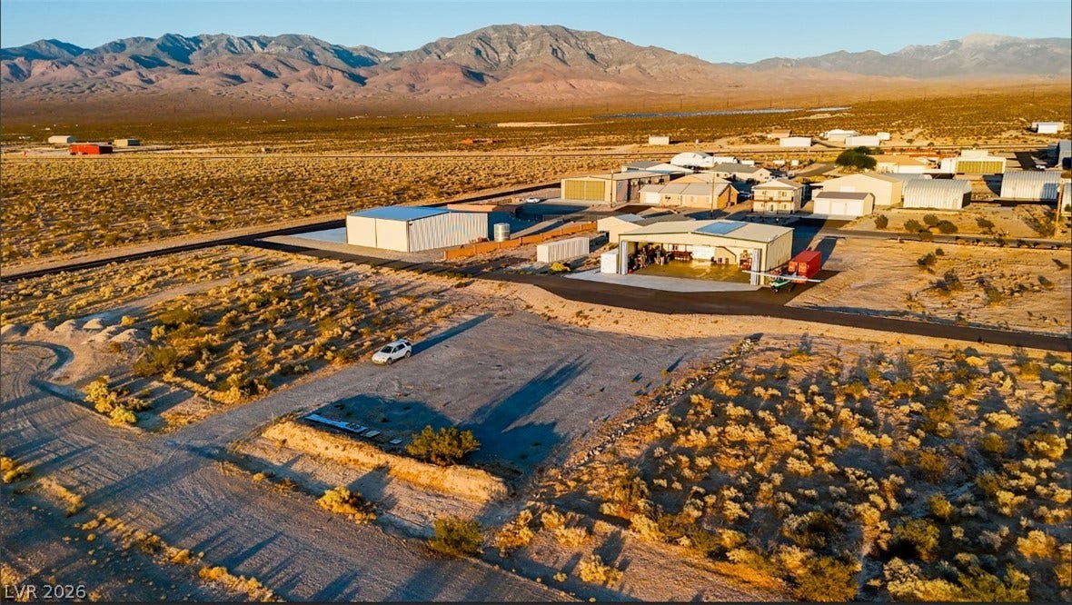 Rugged desert plains meet majestic mountain backdrops surrounding this unique property with hangar space.