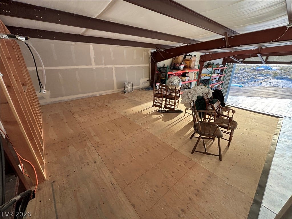 An expansive upper mezzanine level features structural steel framing and subfloor decking ready for customization.
