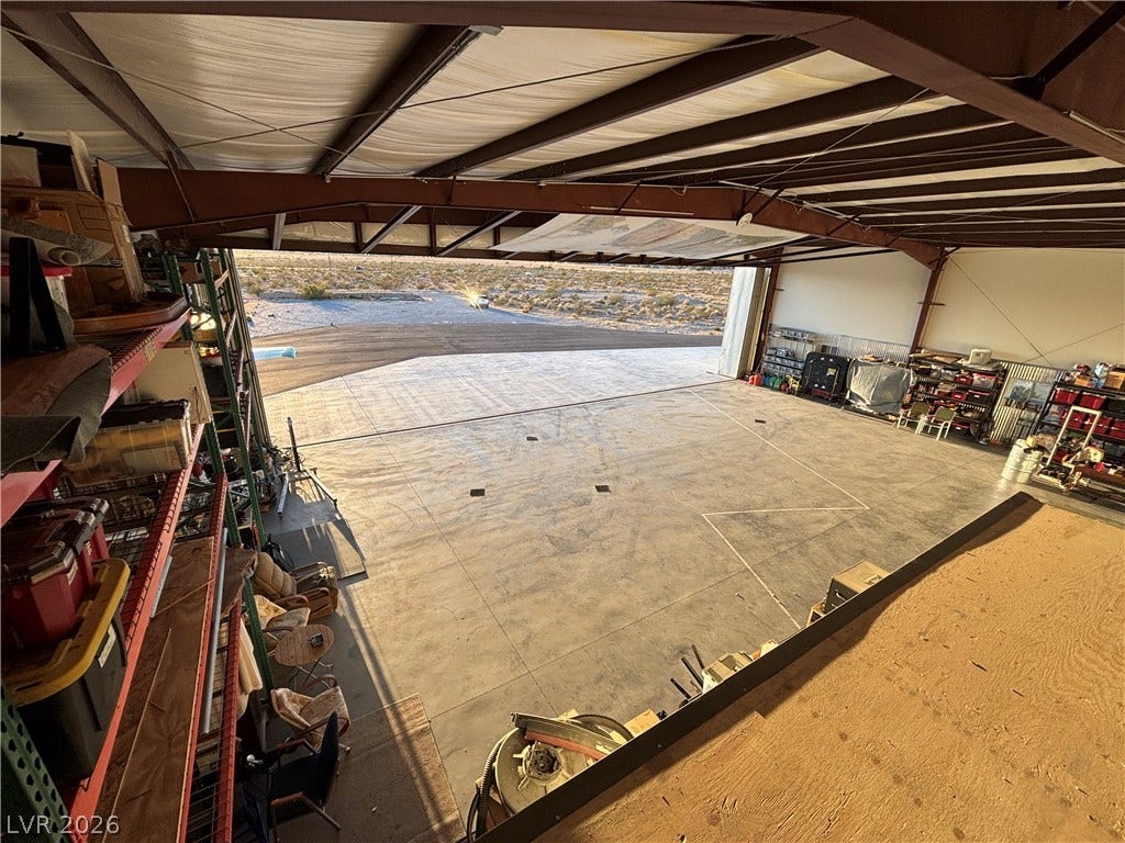 Industrial steel framing and concrete flooring define this versatile outbuilding with wide door access.
