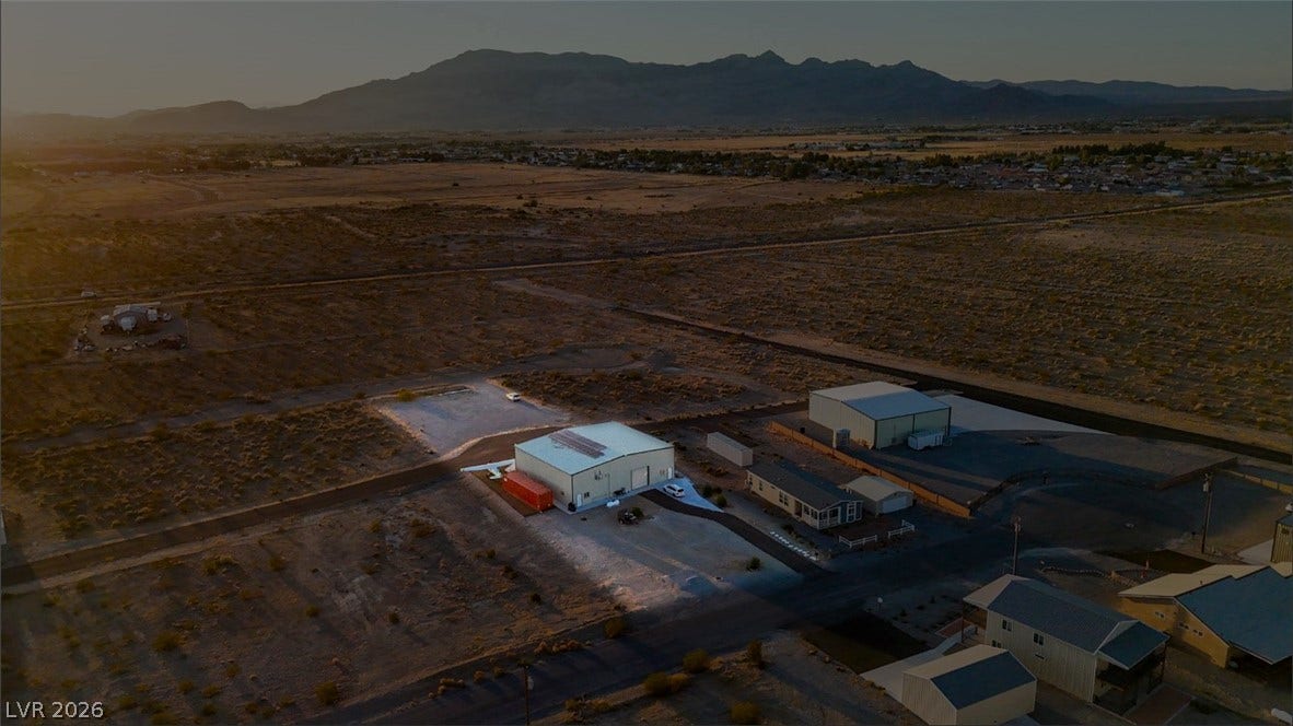 Vast desert horizons and majestic mountain ranges backdrop this expansive property lot.