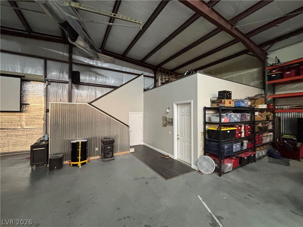 Industrial steel framing and concrete flooring define this versatile outbuilding interior with mezzanine potential.