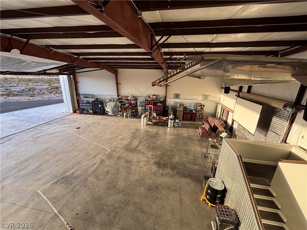 Industrial structural elements and a concrete floor define this expansive hangar space.