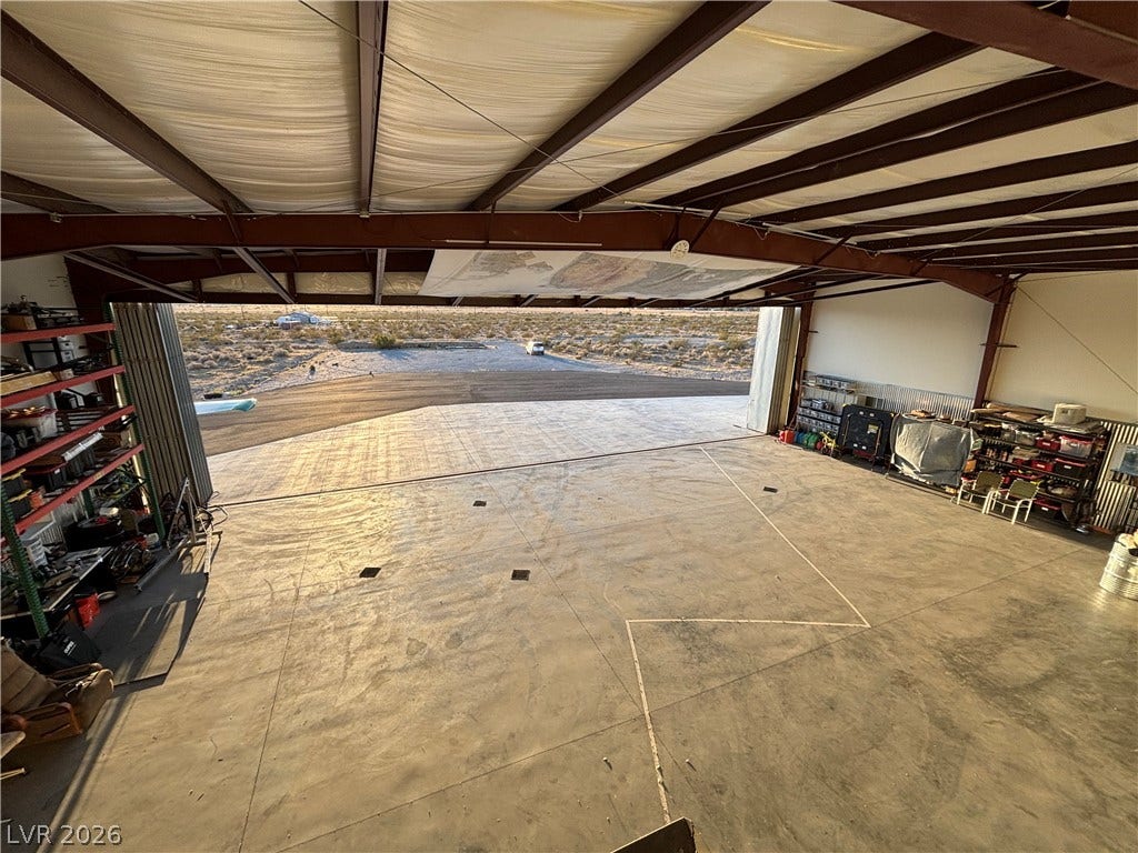 Massive concrete floors and high steel-beamed ceilings define this versatile private airplane hangar.