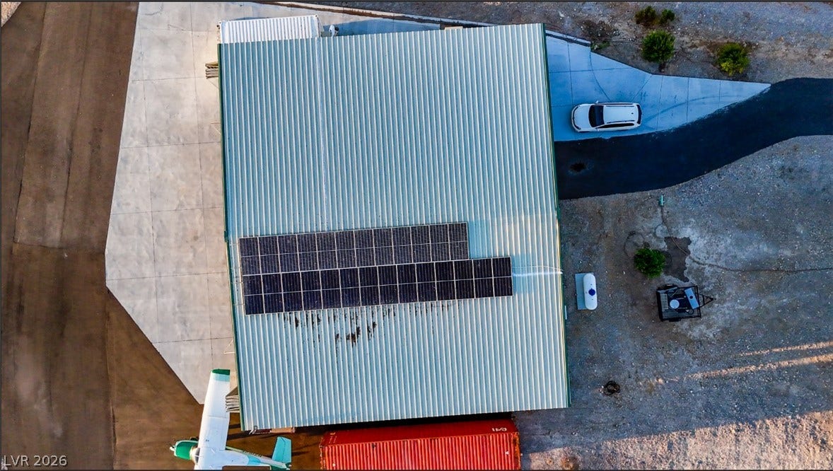 An aerial perspective showcases a metal roof equipped with solar panels.