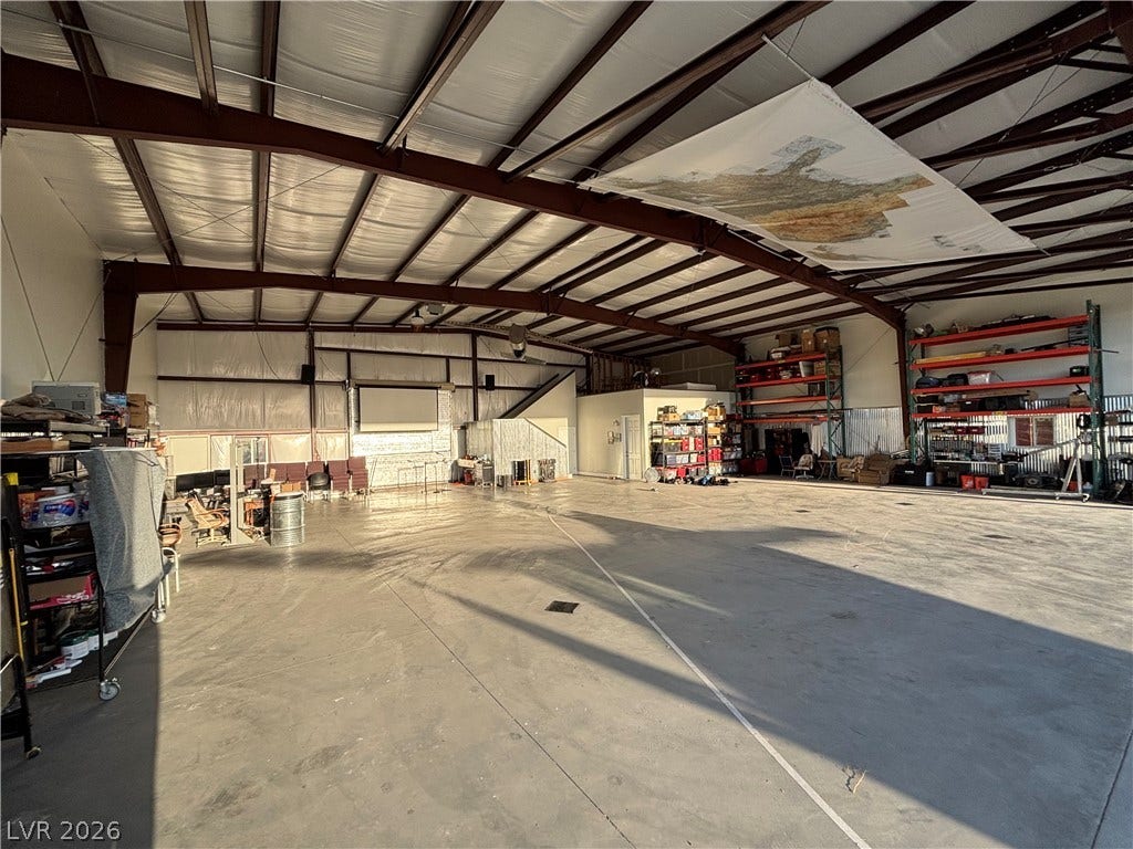 An expansive concrete floor anchors this massive industrial outbuilding with insulated metal framing.