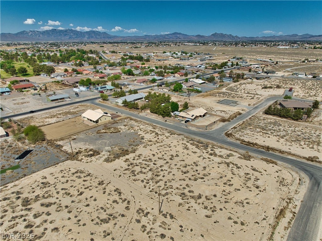 Aerial view featuring a desert view and a mountain view