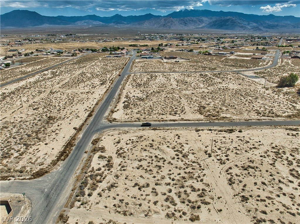 Drone / aerial view featuring a mountain view, a rural view, and a desert view
