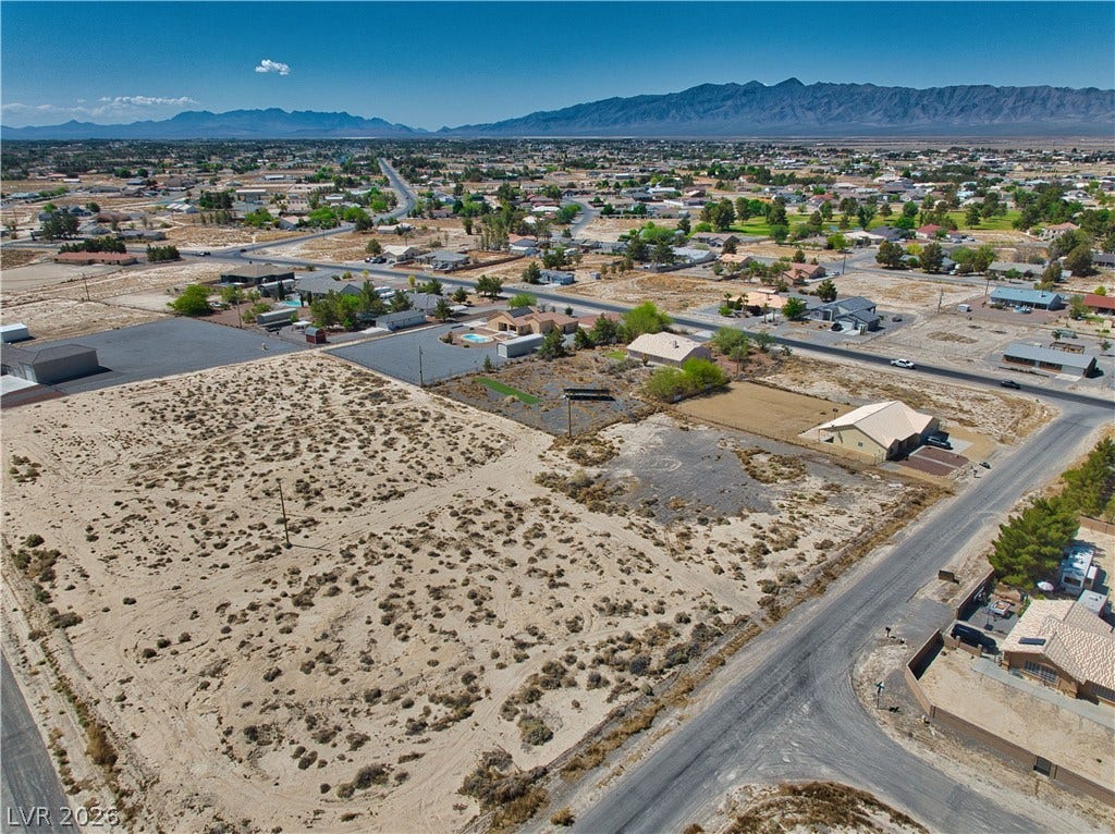 Birds eye view of property with a mountain view