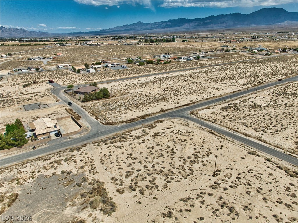 Aerial view featuring a rural view, view of desert, and a mountain view