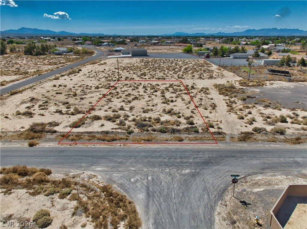 Aerial view of property and surrounding area with mountains and property boundaries highlighted