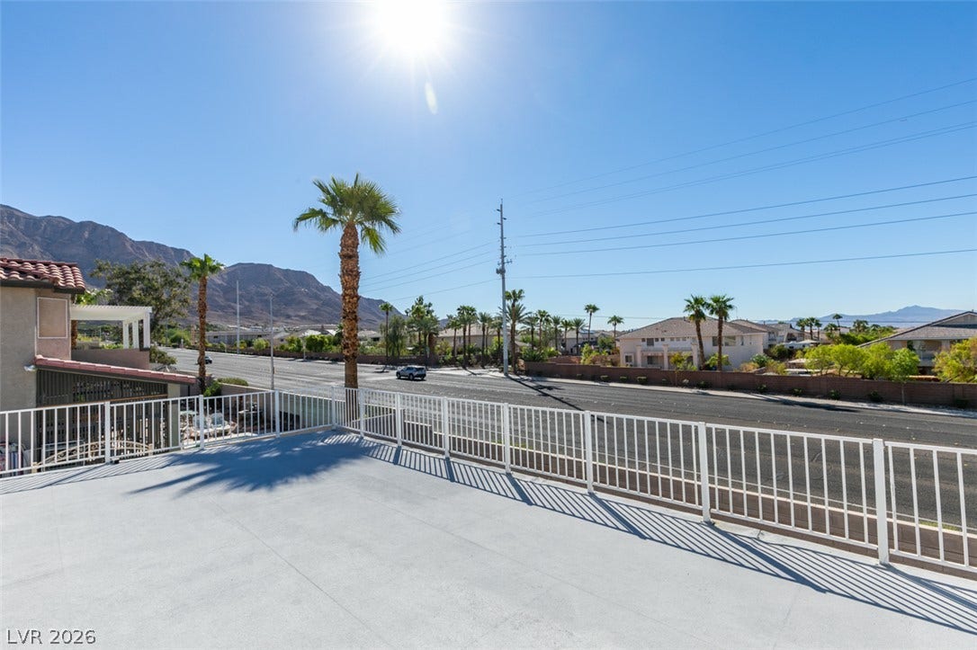 6543 Mahogany Peak Avenue, Las Vegas, NV 89110 Sun-drenched rooftop terrace frames majestic mountain peaks and swaying palm trees.