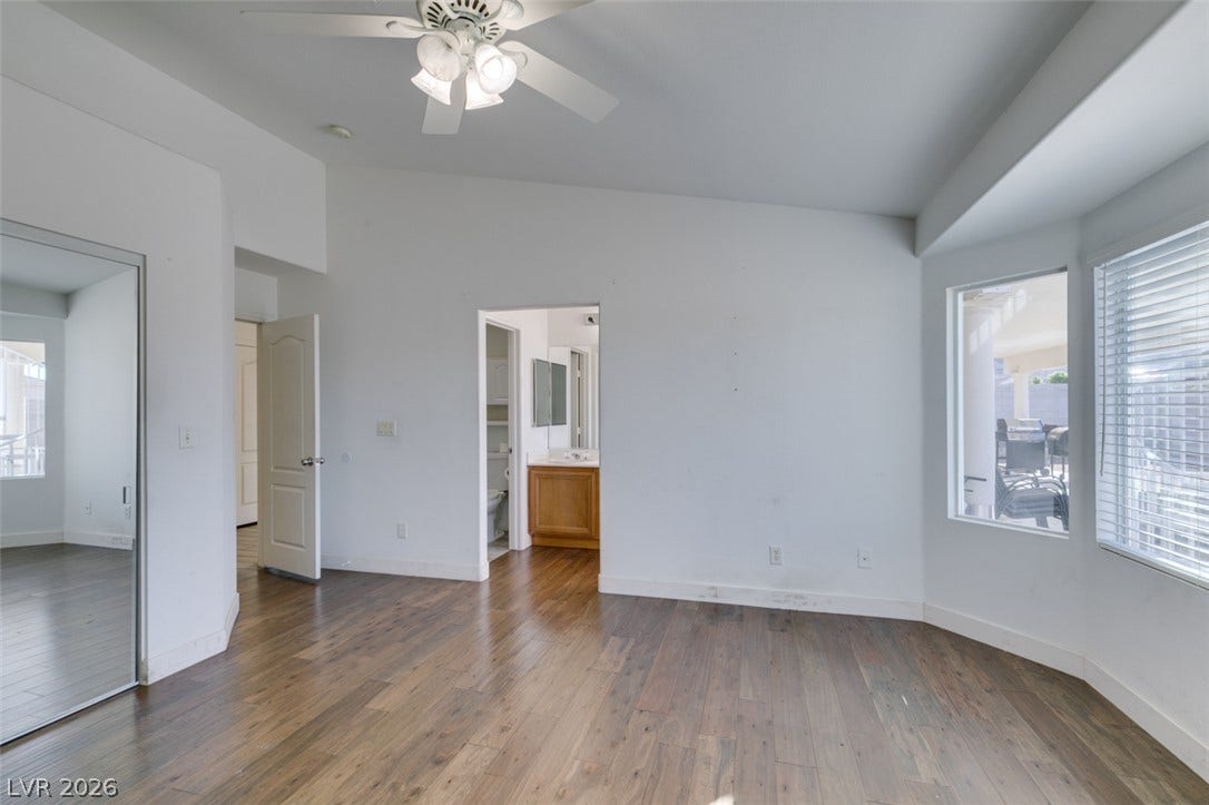 6543 Mahogany Peak Avenue, Las Vegas, NV 89110 Rich wood floors and vaulted ceilings create an open, airy feeling throughout the bedroom.