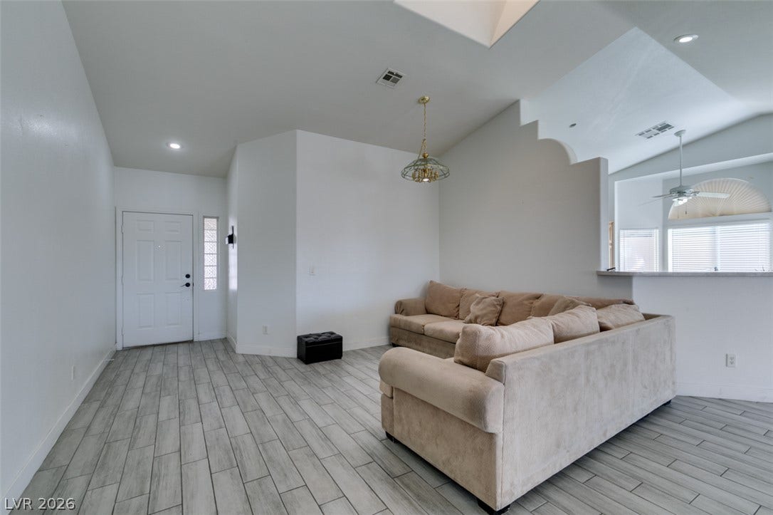 6543 Mahogany Peak Avenue, Las Vegas, NV 89110 Gleaming tile floors and vaulted ceilings create a welcoming entry into the living space.
