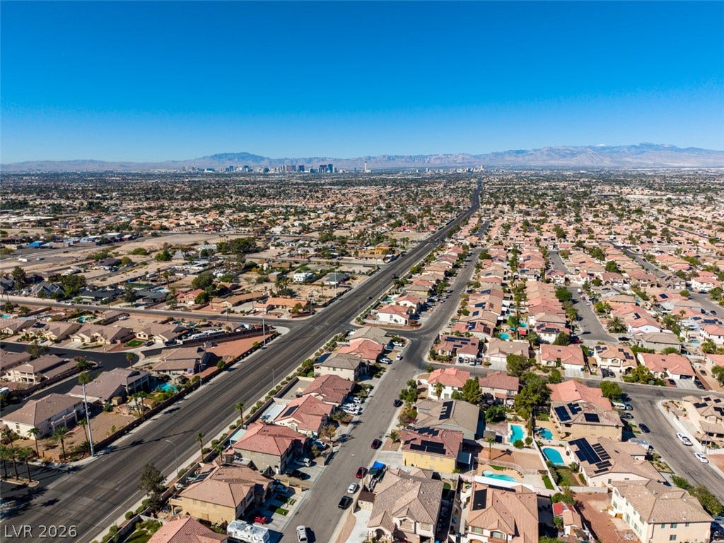 6543 Mahogany Peak Avenue, Las Vegas, NV 89110 A sweeping panorama captures the vibrant neighborhood layout set against a distant mountain backdrop.