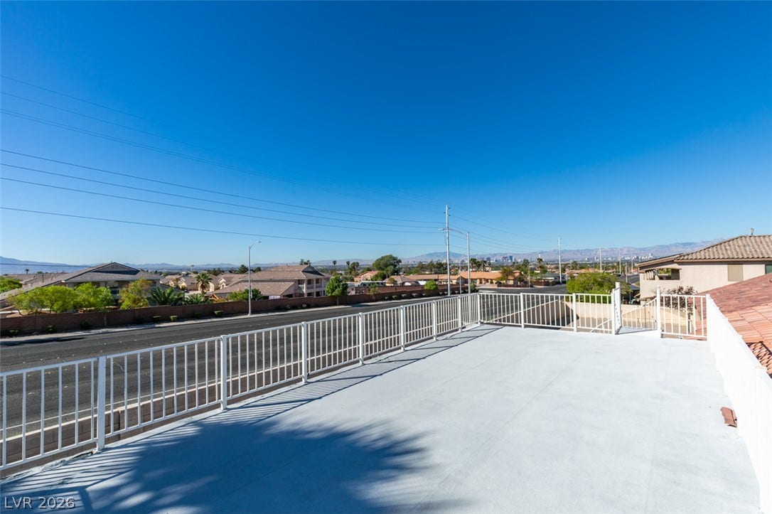 6543 Mahogany Peak Avenue, Las Vegas, NV 89110 An expansive upper balcony and covered patio overlook the spacious backyard with beautiful views of the Las Vegas Strip.