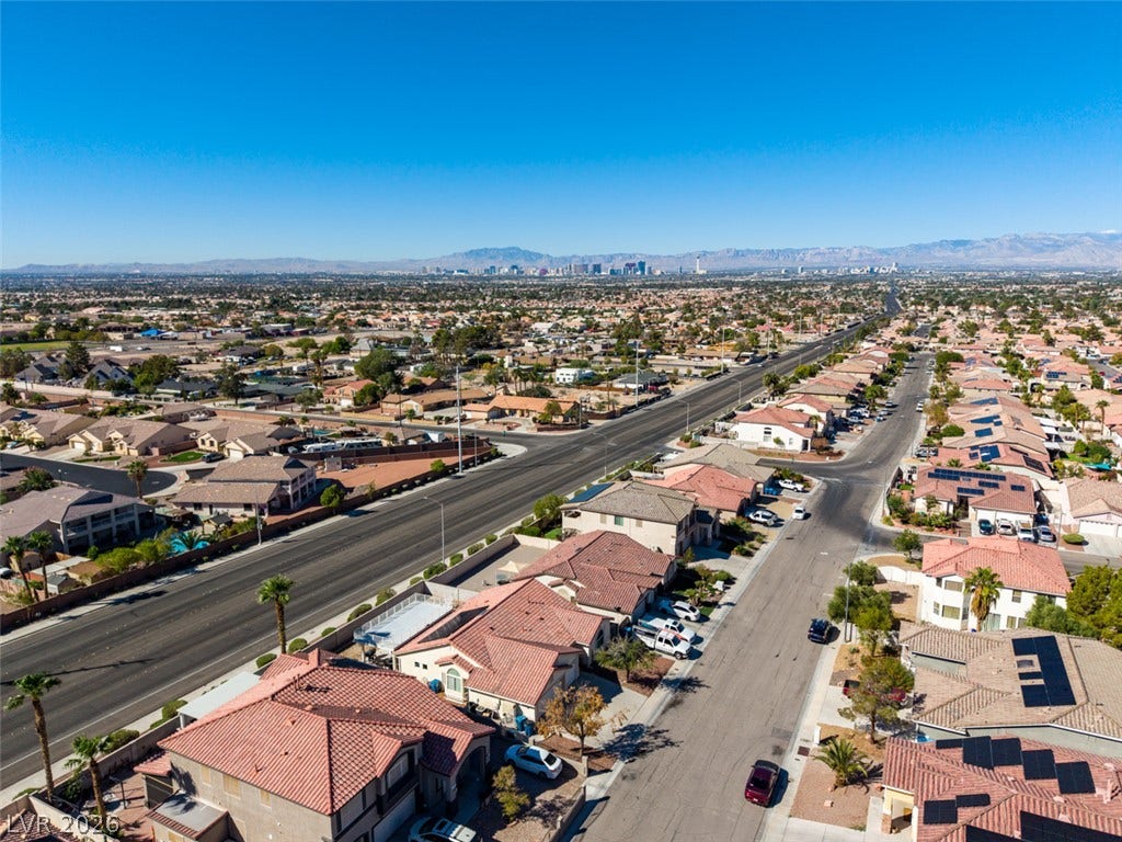 6543 Mahogany Peak Avenue, Las Vegas, NV 89110 Distant city skyline views and mountain ridges frame this sprawling residential neighborhood panorama.