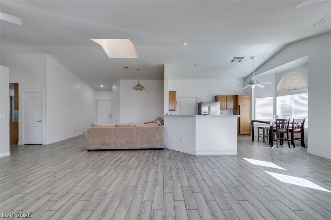 6543 Mahogany Peak Avenue, Las Vegas, NV 89110 Vaulted ceilings and wood-look flooring enhance the open flow of this versatile living space.