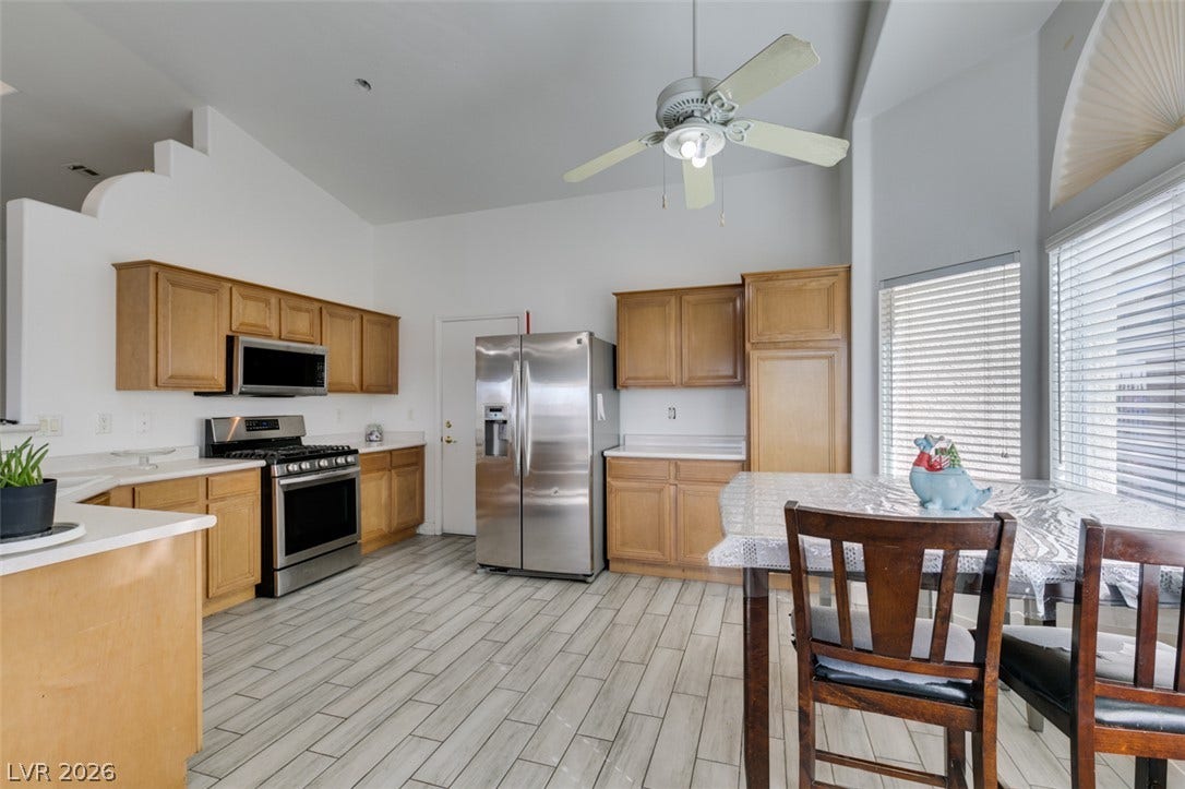 6543 Mahogany Peak Avenue, Las Vegas, NV 89110 High ceilings and durable tile flooring highlight this airy kitchen and dining area.