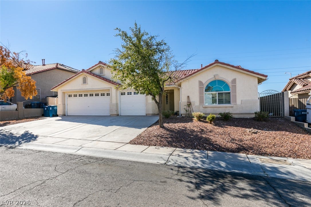 6543 Mahogany Peak Avenue, Las Vegas, NV 89110 Spanish tile roofing and an arched window highlight the classic stucco exterior of this home.