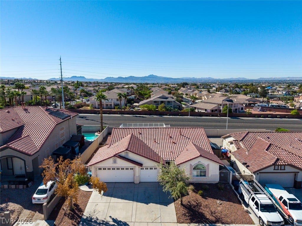6543 Mahogany Peak Avenue, Las Vegas, NV 89110 Distant mountains frame this neighborhood view of tile-roofed residences.