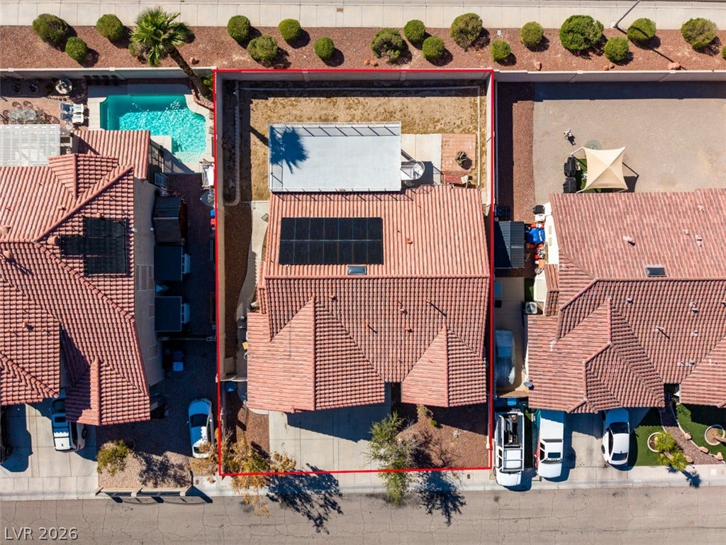6543 Mahogany Peak Avenue, Las Vegas, NV 89110 An aerial perspective showcases the tile roof equipped with solar panels and a private backyard.