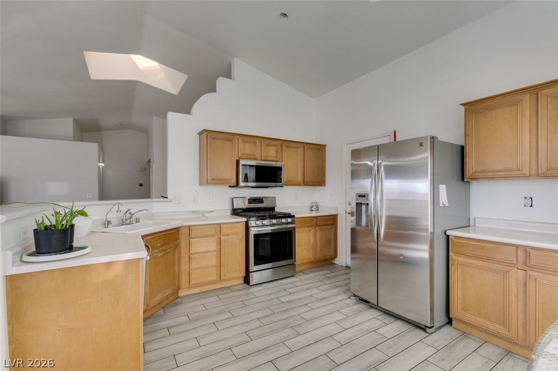 6543 Mahogany Peak Avenue, Las Vegas, NV 89110 Angled ceilings and tile flooring enhance this open kitchen layout.