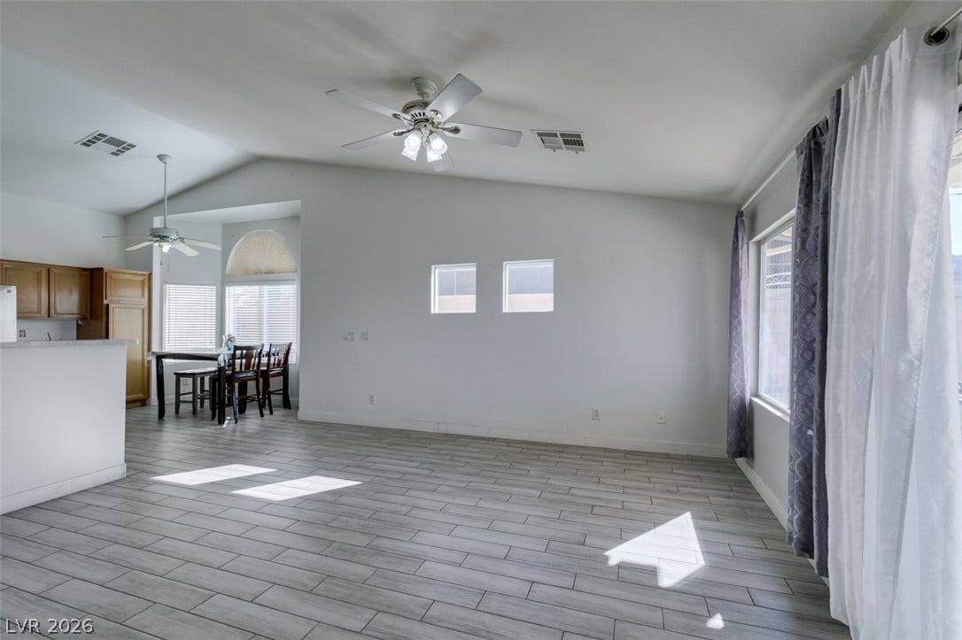 6543 Mahogany Peak Avenue, Las Vegas, NV 89110 Abundant natural light streams across modern plank tile floors in this spacious living area.