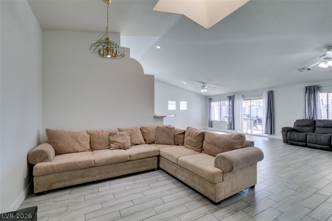 6543 Mahogany Peak Avenue, Las Vegas, NV 89110 Clean tile flooring and a vaulted ceiling elevate this open, airy living area.