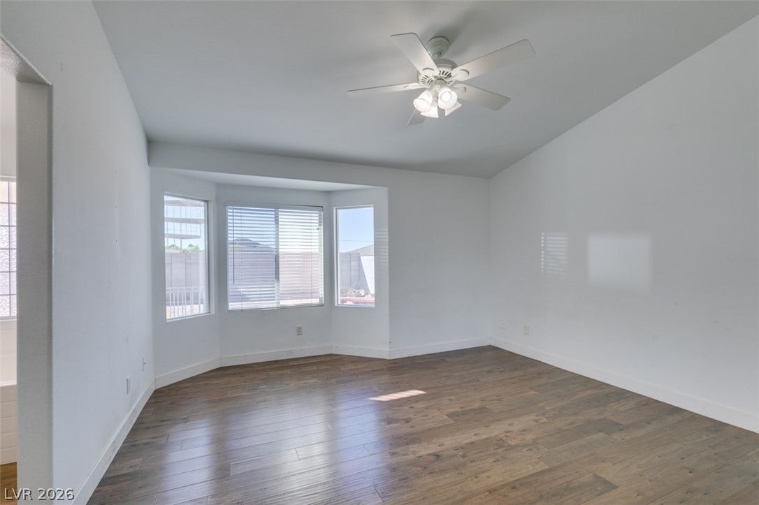 6543 Mahogany Peak Avenue, Las Vegas, NV 89110 Rich wood flooring anchors this versatile space illuminated by a classic bay window.