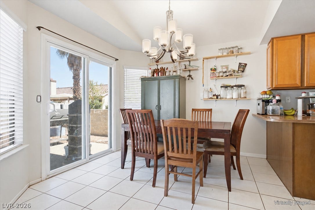 3960 Grapefruit Circle, Las Vegas, NV 89103 Tiled flooring and large glass doors leading outside define this bright dining space.