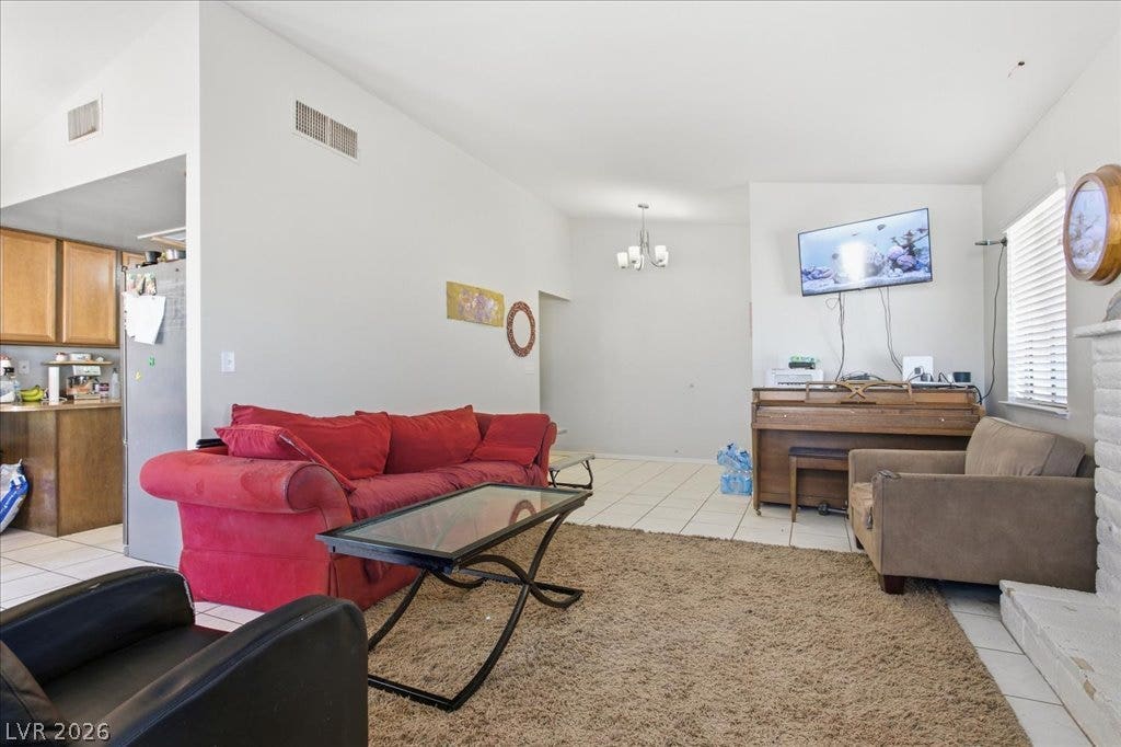 3960 Grapefruit Circle, Las Vegas, NV 89103 High ceilings and clean tile flooring define this airy, open-concept living space.